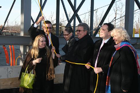 Local officials gather to participate in the UMass Dartmouth Topping-off Event (from left to right): Katherine Craven, Executive Director, UMass Building Authority; State Senator Michael Rodrigues; Dr. Susan Windham-Bannister, President & CEO, Massachusetts Life Sciences Center; Robert Caret, UMass President; William Flanagan, Fall River Mayor; Mardee Xifaras, UMass Board of Trustees.