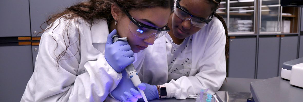 2 High School Apprenticeship Students working in lab together.